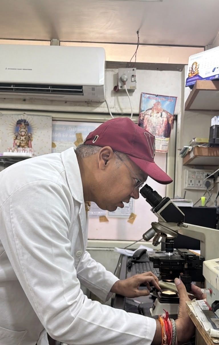 Dr. Palak Shah examining a sample under the microscope